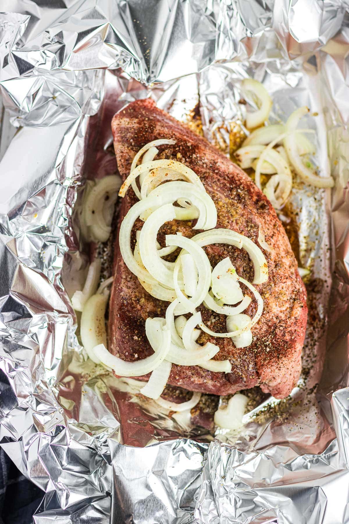 Brisket in foil with garlic and onions.