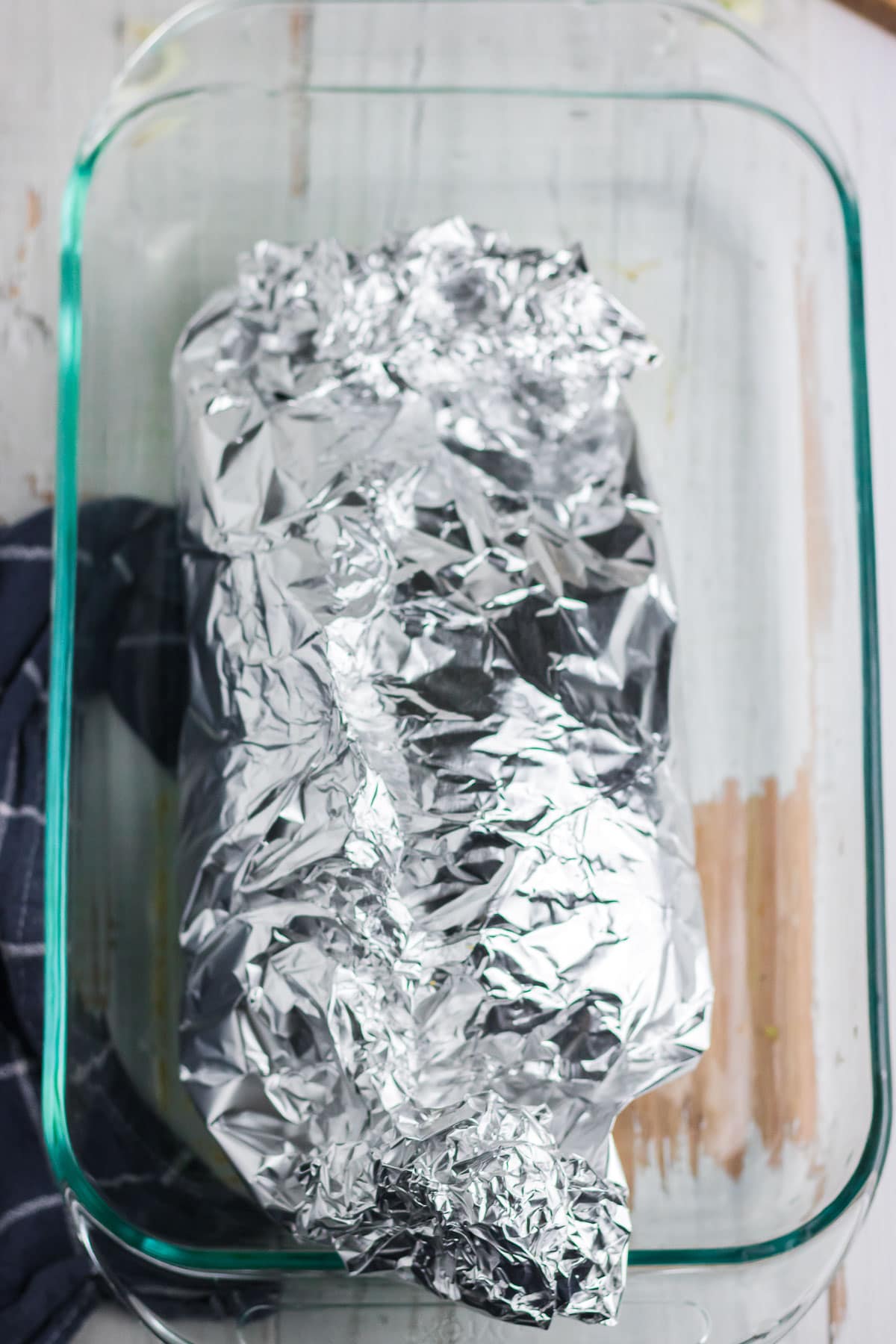 Brisket wrapped tightly in foil.