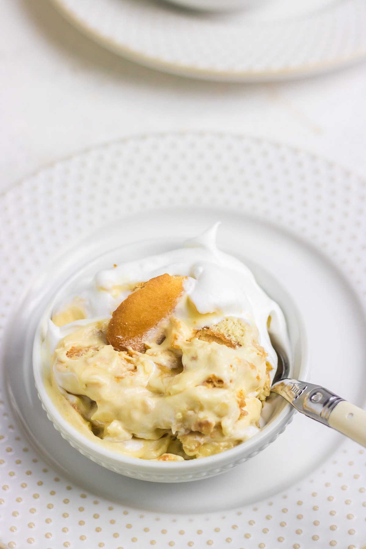 A small bowl of Southern banana pudding with a spoon.