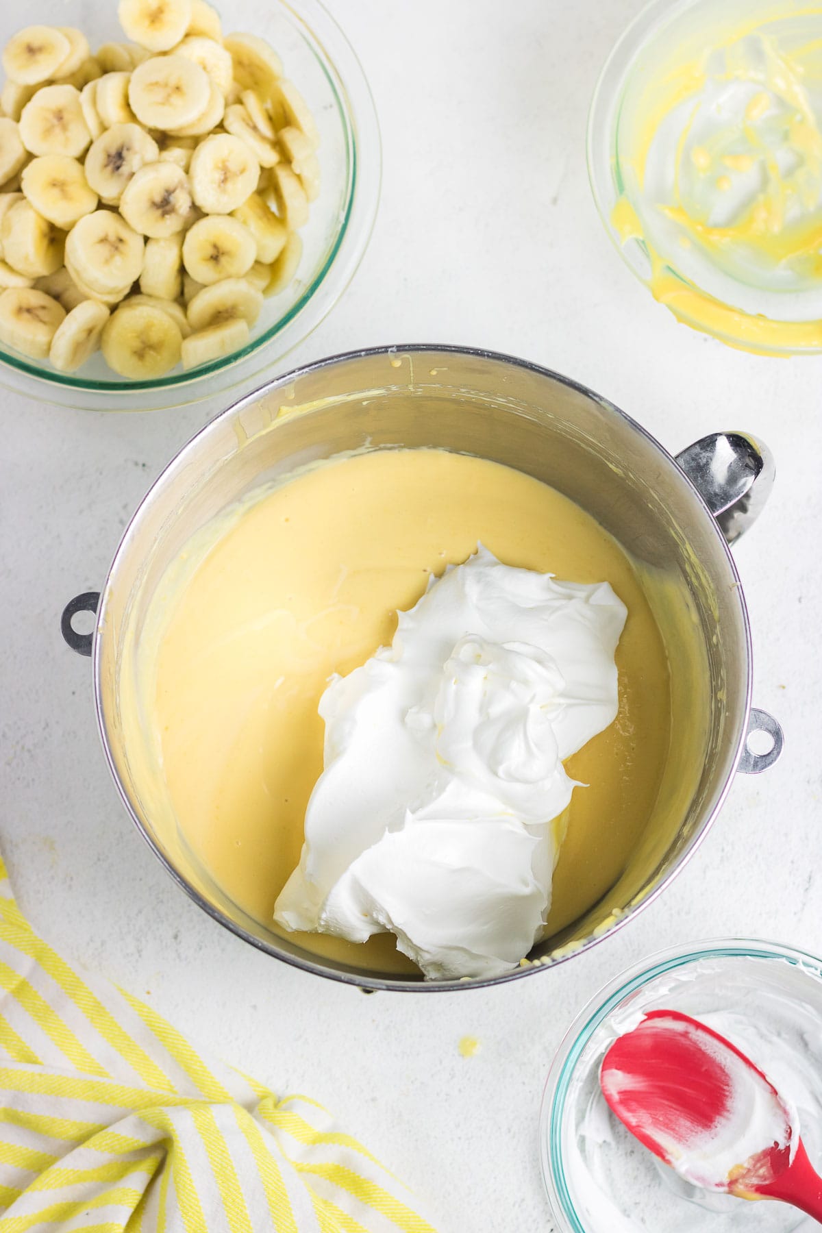 The pudding mixture with a scoop of whipped topping to be mixed together.