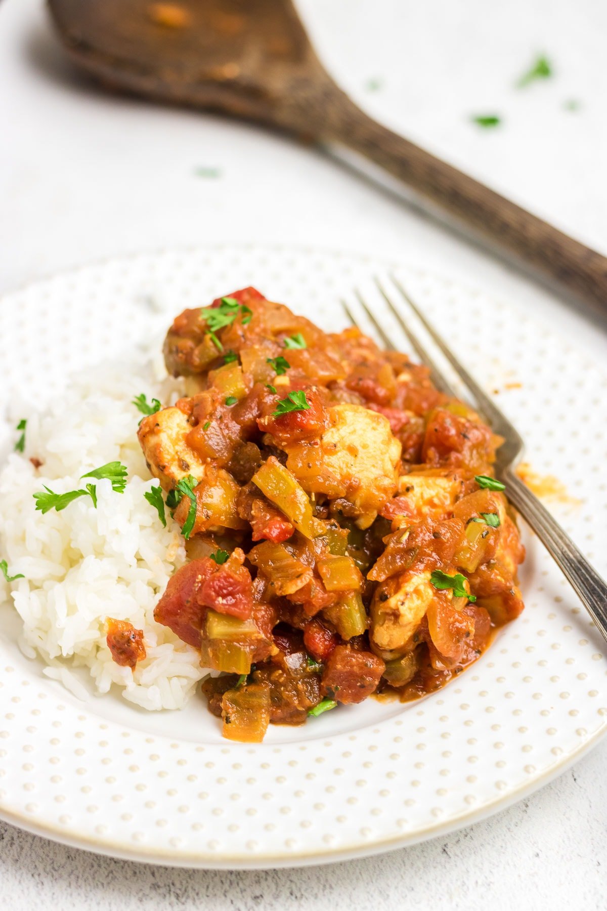 Creole chicken and rice on a dinner plate.