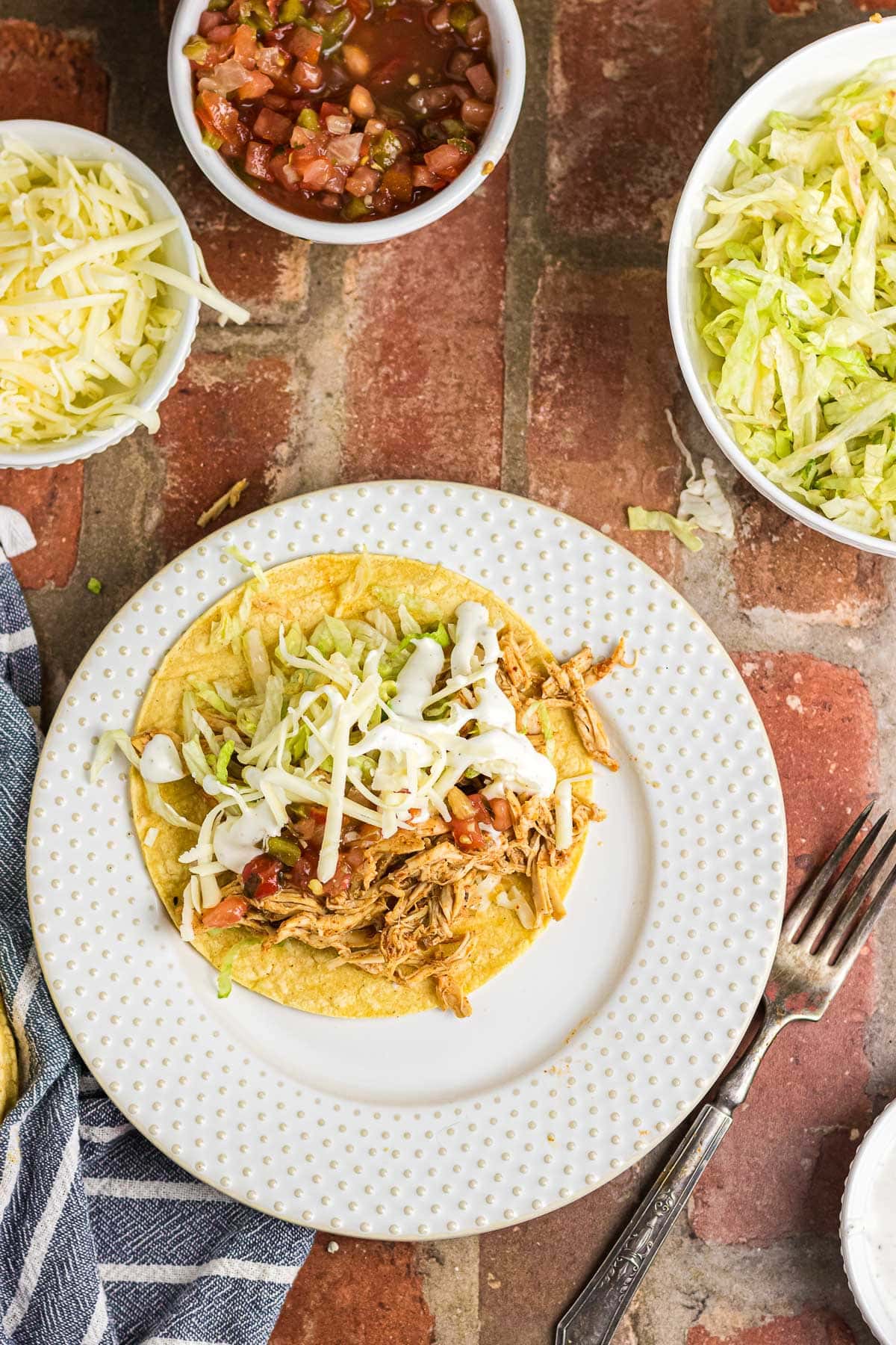 A ranch chicken taco topped with lettuce, tomatoes, and sour cream.