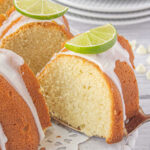 A slice of lime bundt cake being served with a text title overlay for Pinterest.