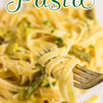 Closeup of a dish of lemon asparagus pasta with title text overlay for Pinterest.