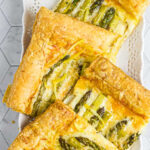 Overhead view of slices of asparagus tart with title text overlay for Pinterest.