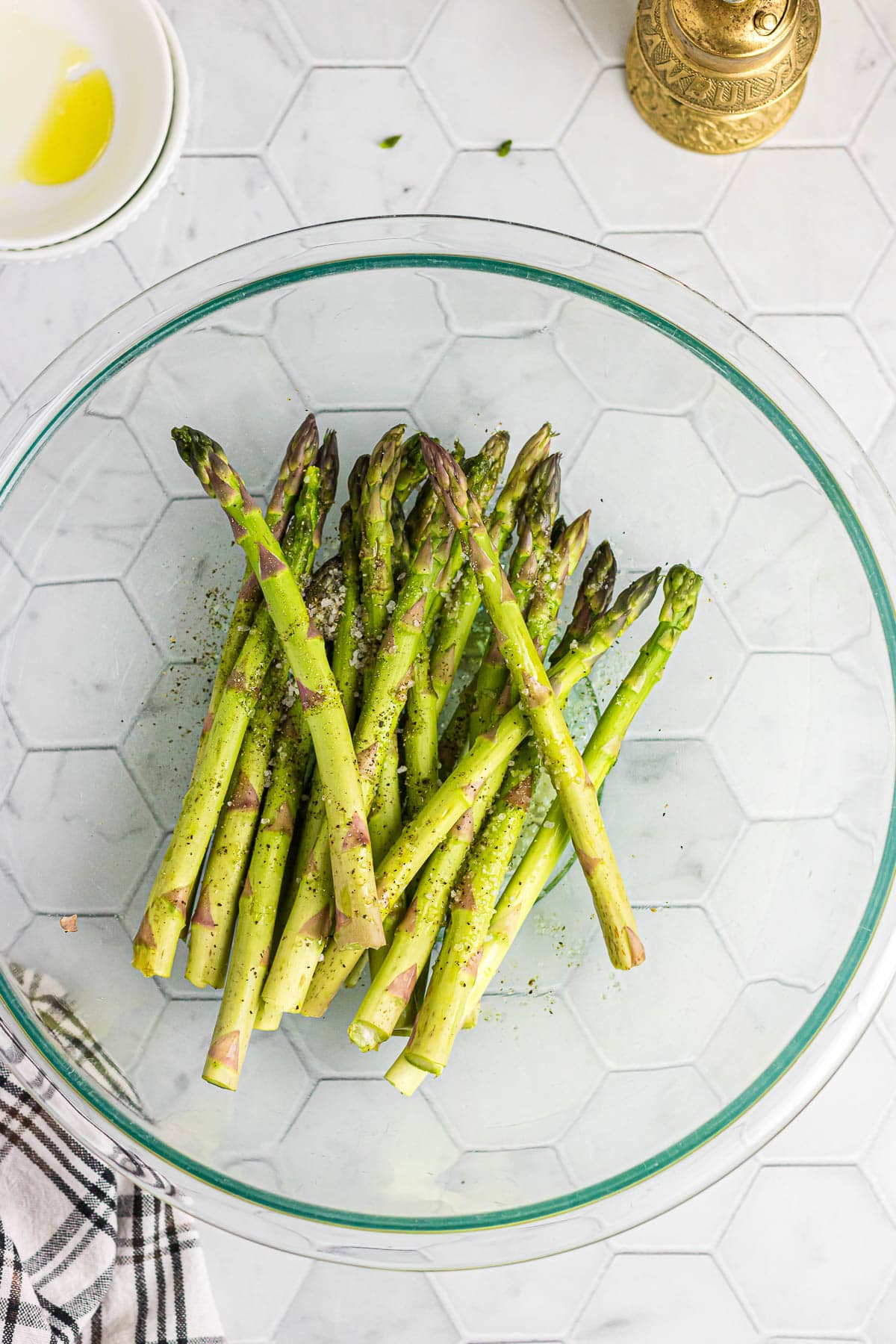 Asparagus spears in a glass bowl.