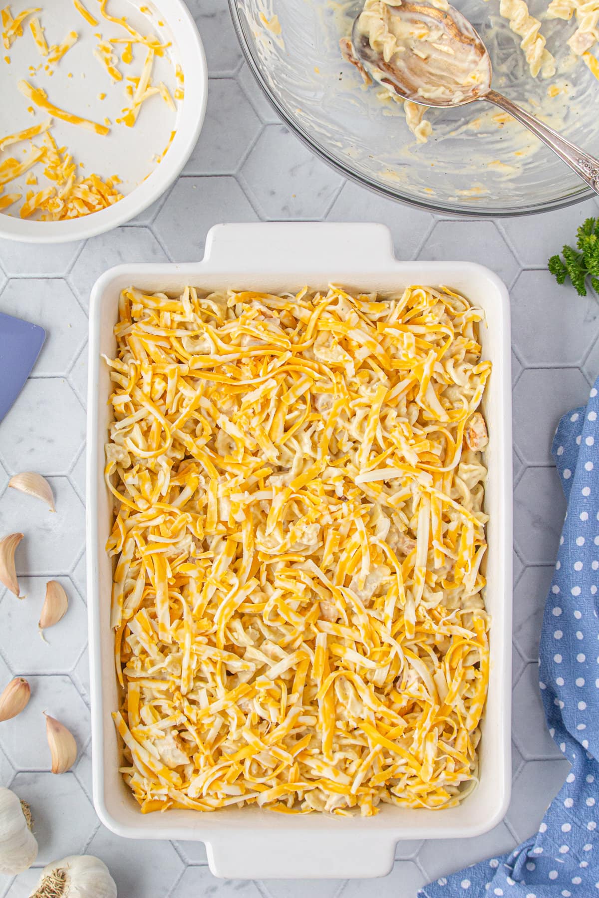 The ingredients spread in a casserole dish, topped with cheese.