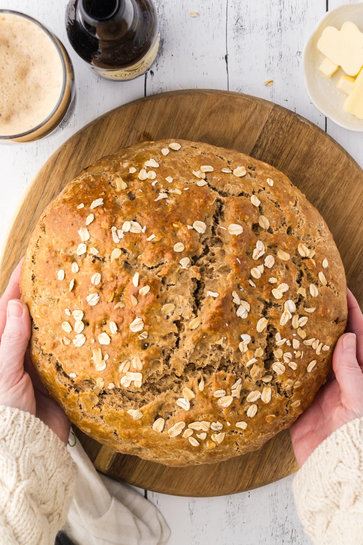 Overhead view of a finished loaf of Guinness Irish Soad Bread being put on a board.