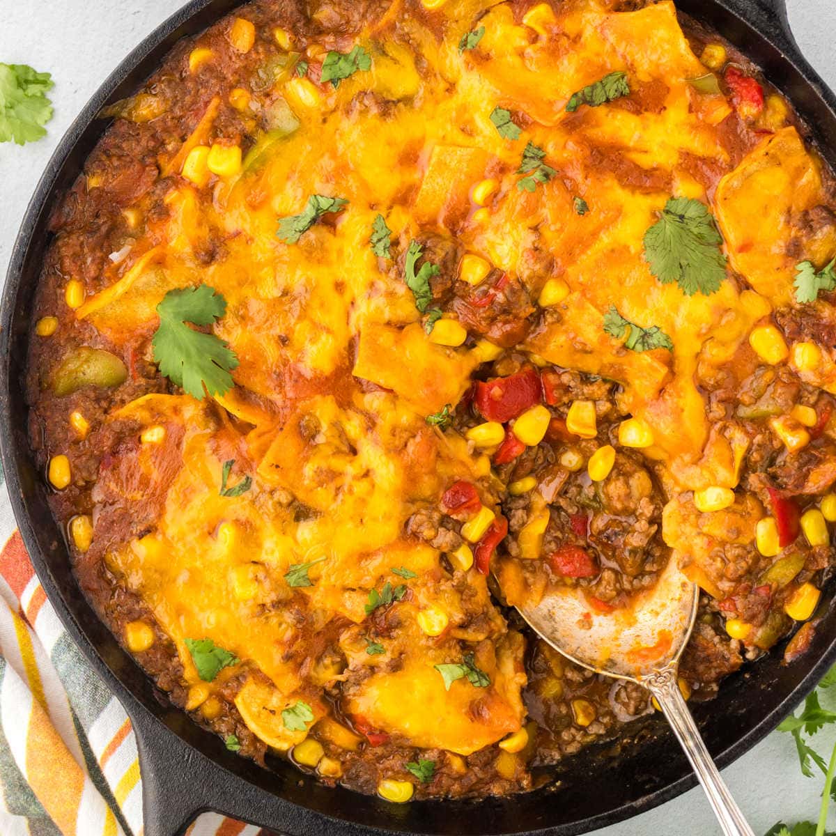 Overhead view of the tamale skillet dinner with a spoon in it.