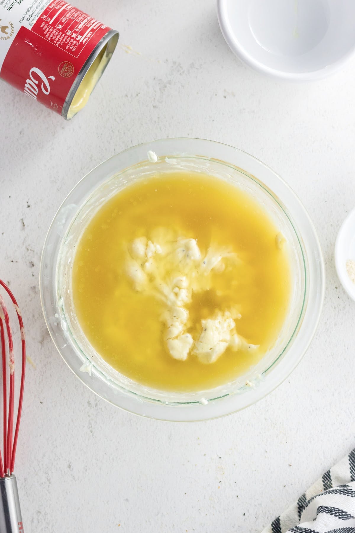 Chicken stock is added to bowl.