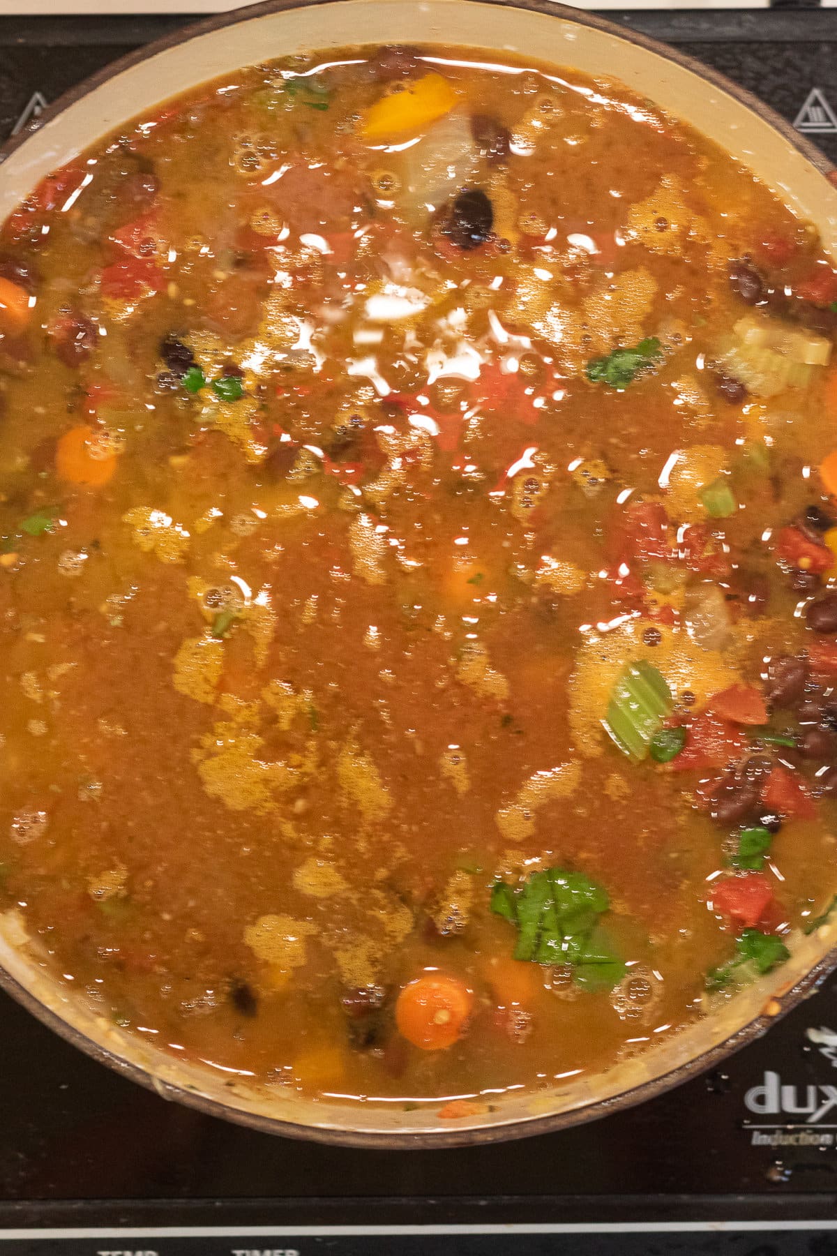 Overhead view of stockpot with stock added.