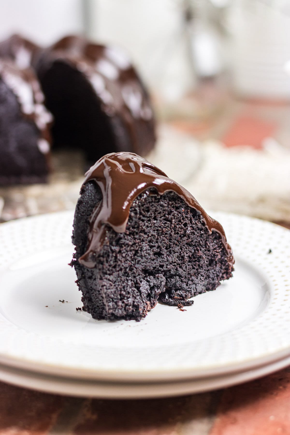 A slice of cake on a white plate.