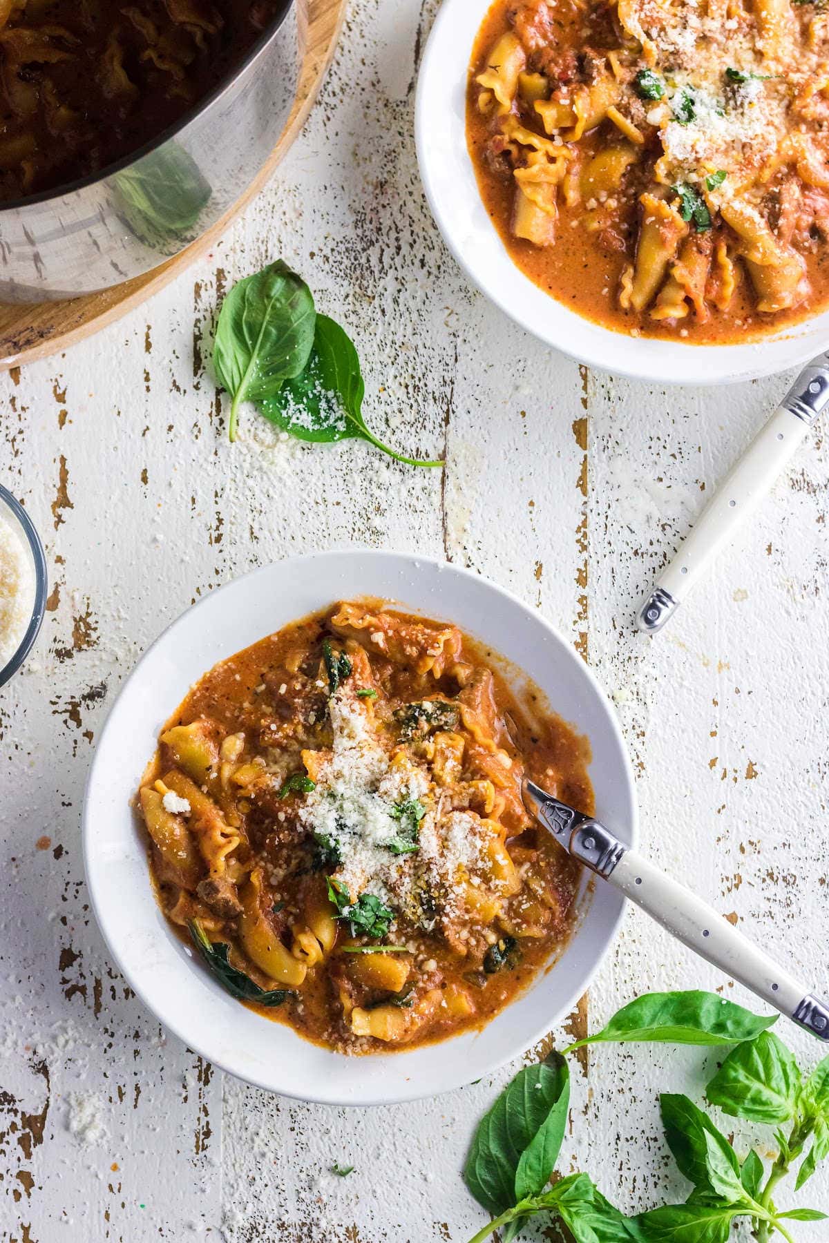 Overhead view of bowls of lasagna soup on the table.