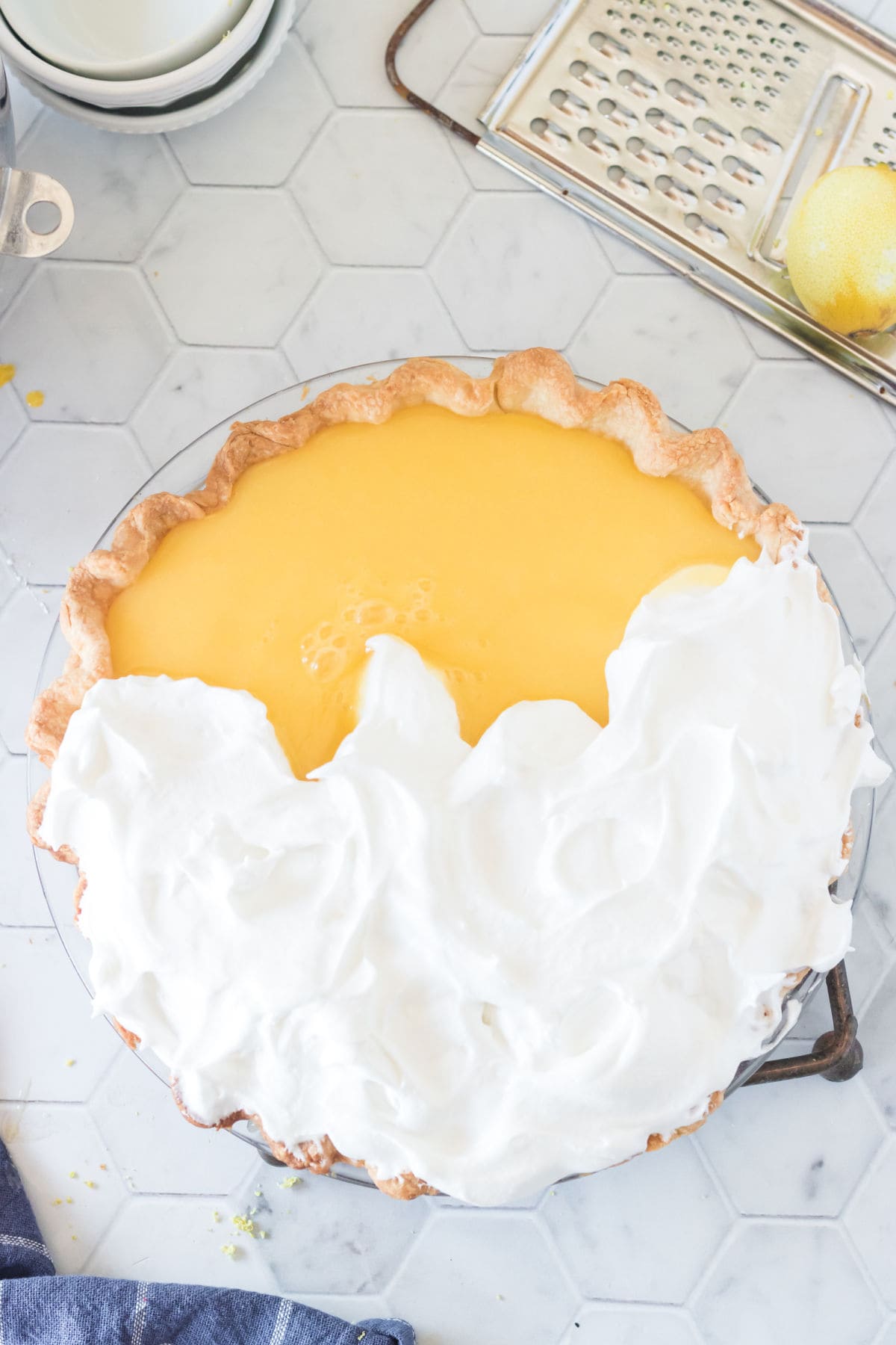 Pie is covered with meringue before baking.