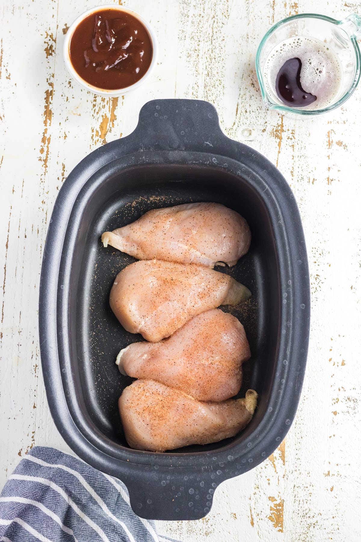 Season chicken and put in the slow cooker.