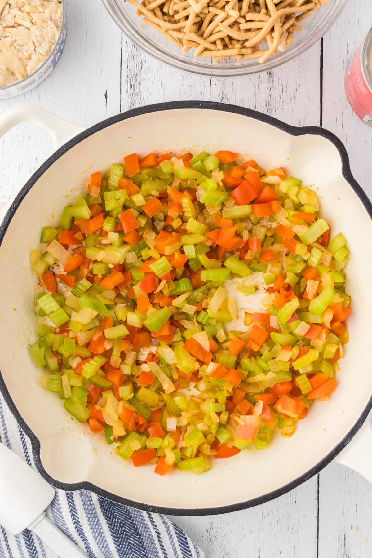 Veggies sautéing in a pot.