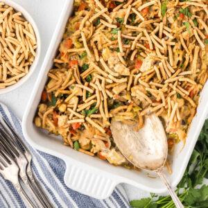 Overhead view of chopstick tuna casserole with a spoon in the casserole dish.