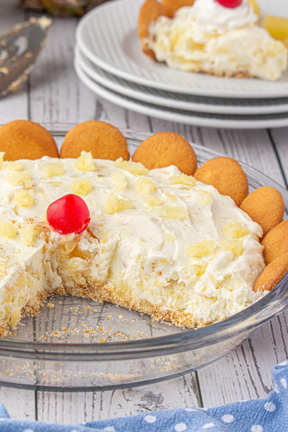 Fluffy pineapple pie in the pie dish with a slice removed. 