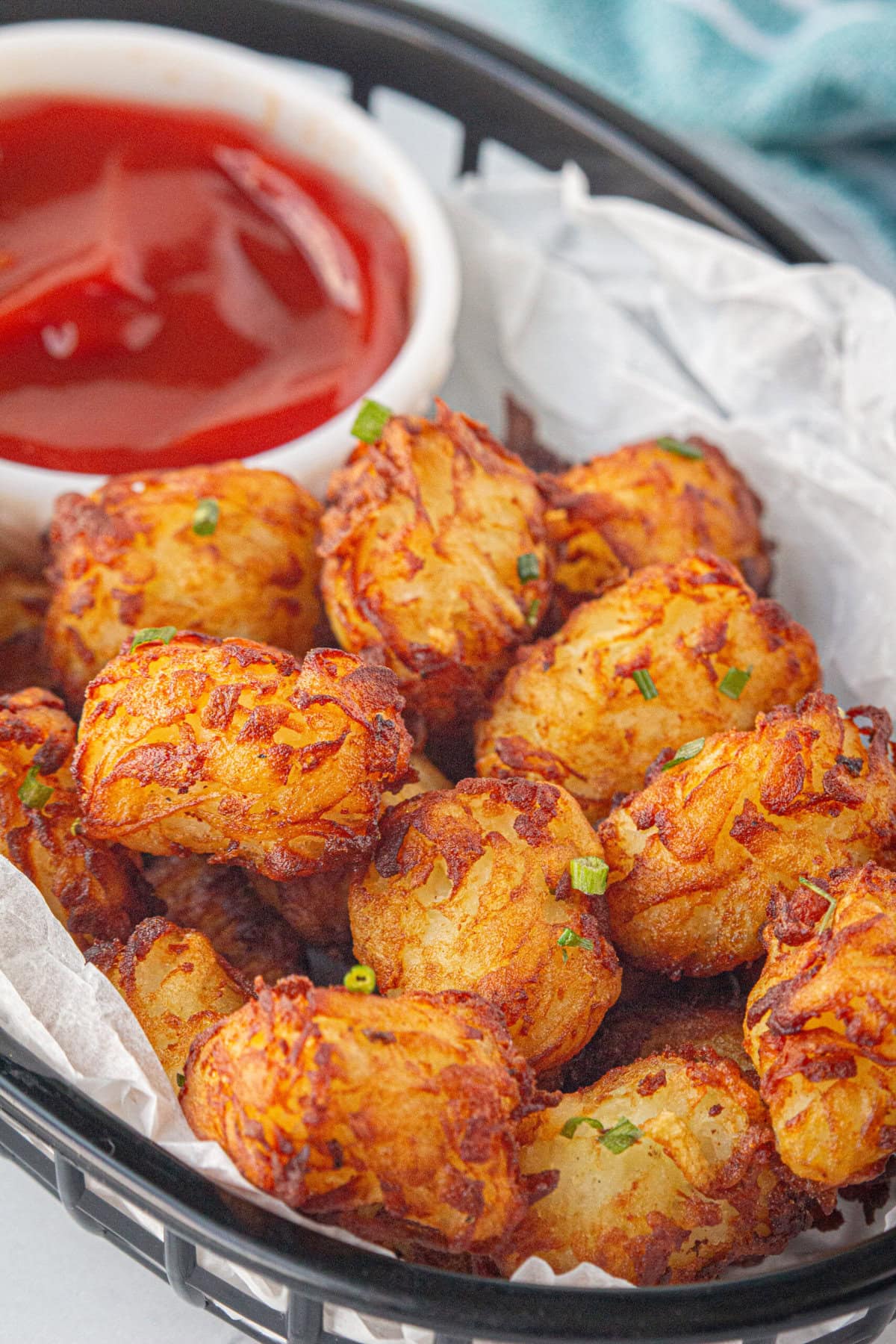 A closeup of homemade tater tots in a bowl.