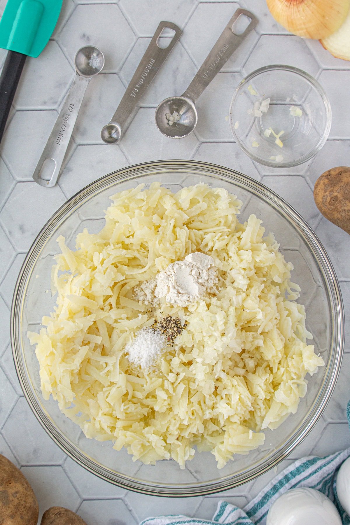 Grated potatoes with flour, salt, and pepper added.