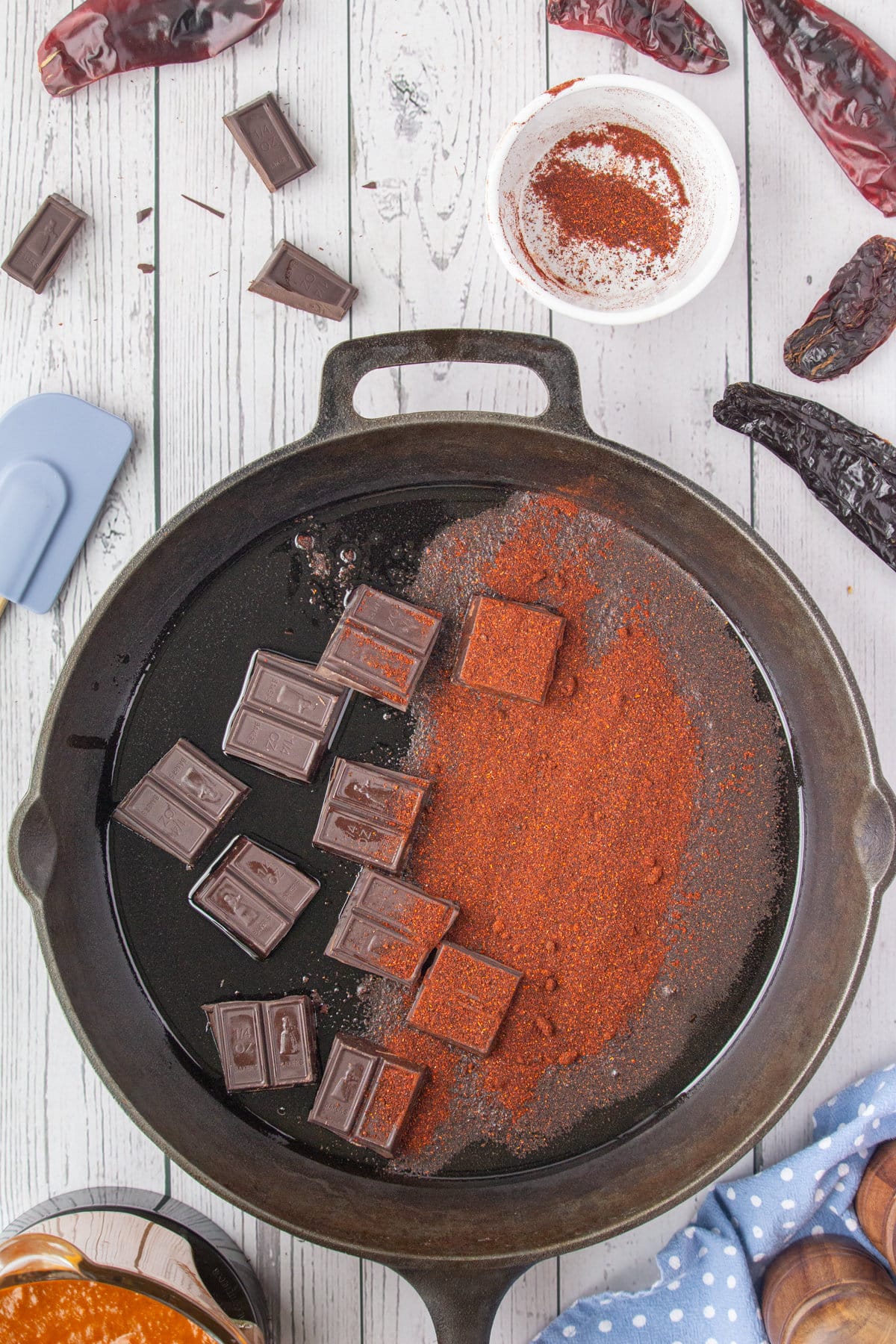 Chocolate squares and chile powder in the skillet.