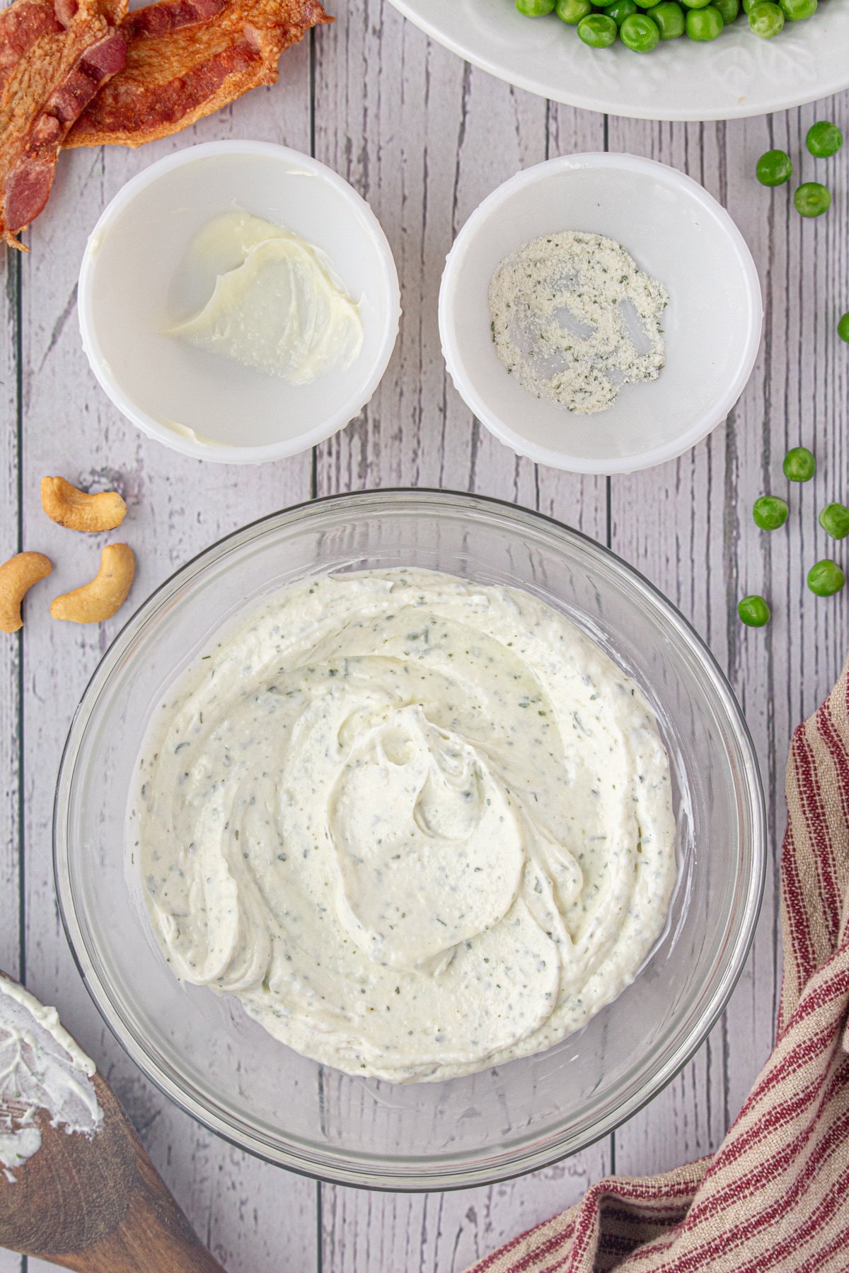The sour cream, mayo, and Ranch dressing mix combined in a bowl.