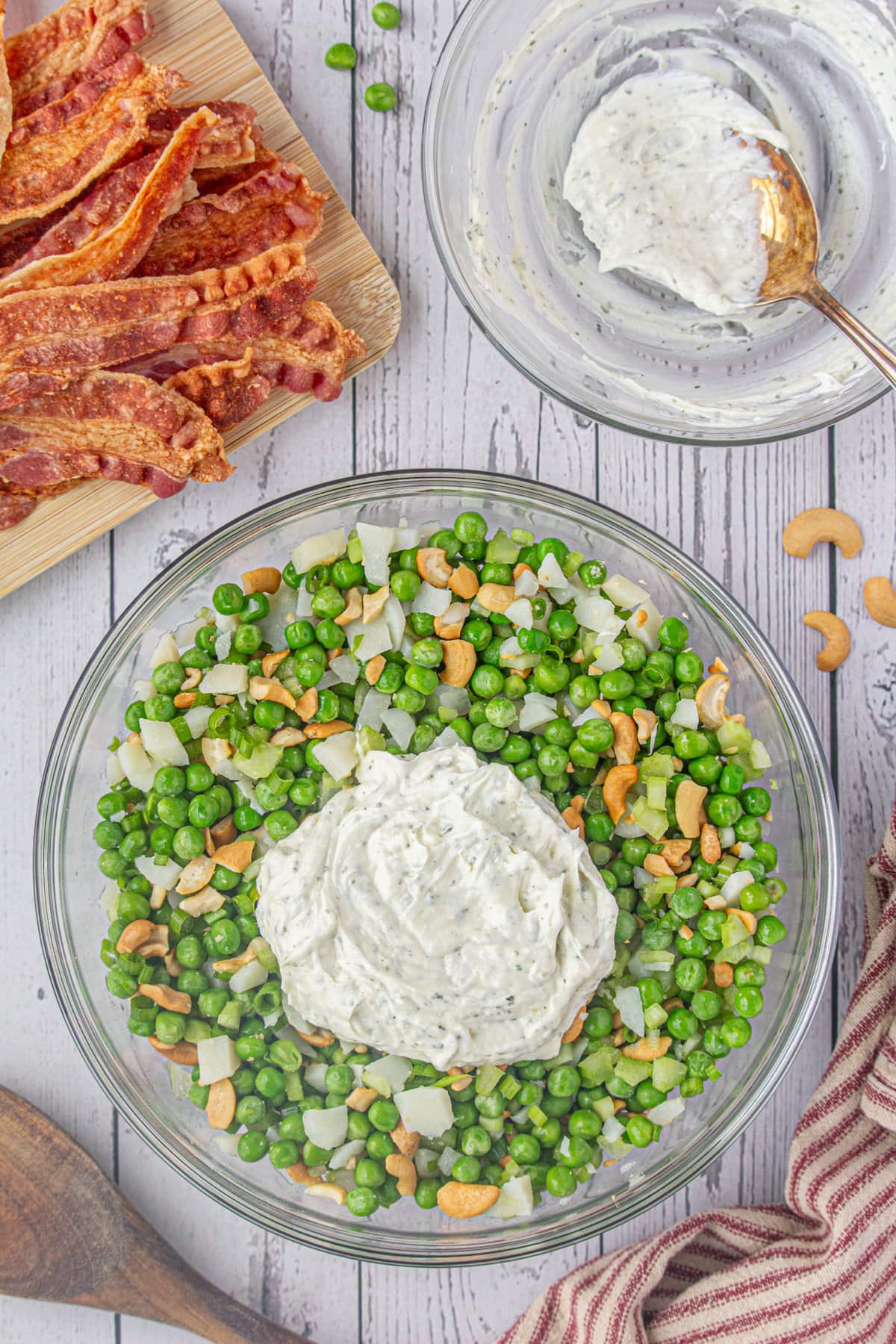 The veggies in a bowl topped with the dressing mixture.