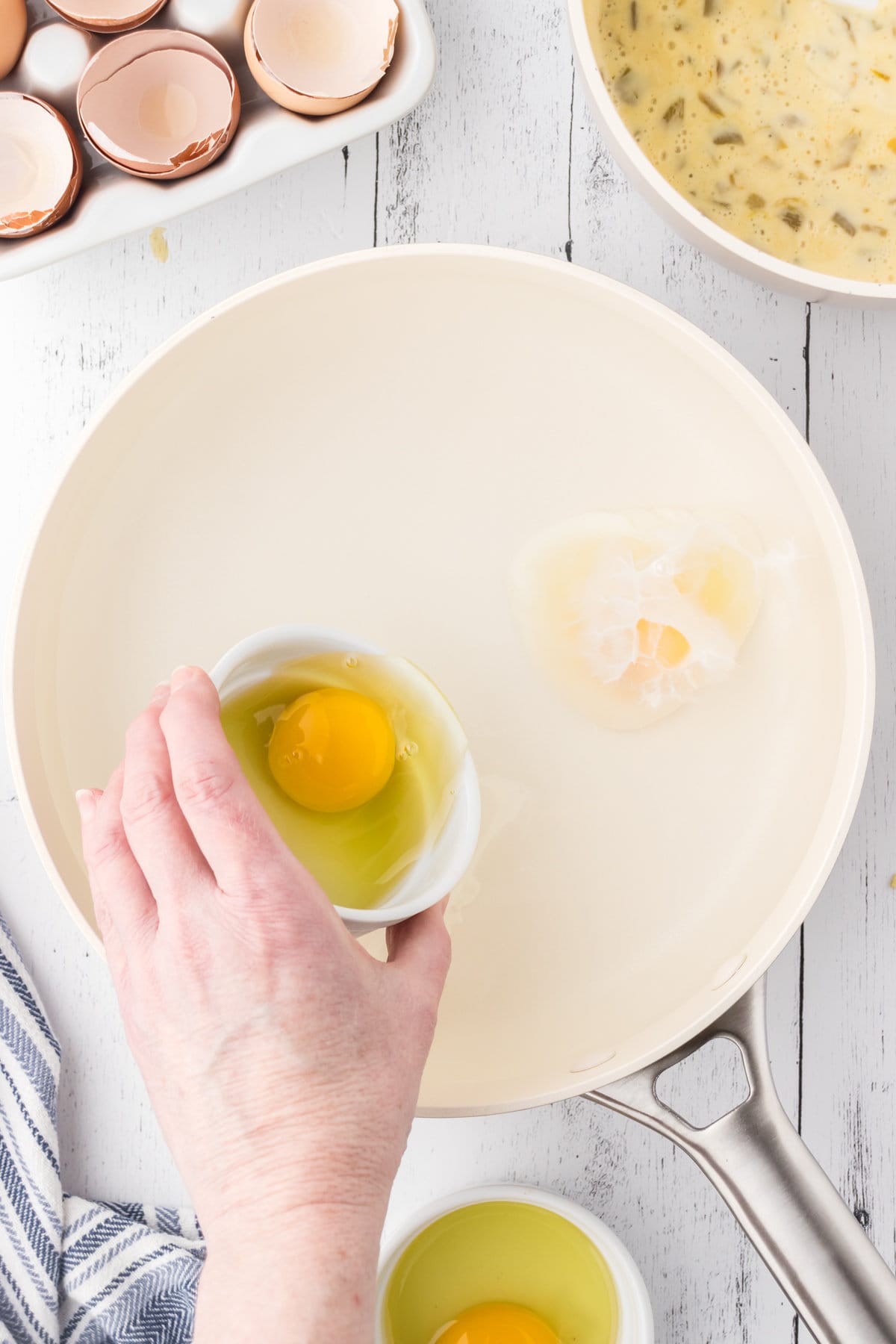 An eggs being added to simmering water.