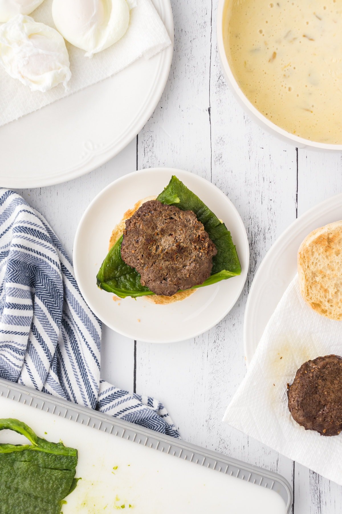 A cooked sausage patty is added to the top of the poblano.