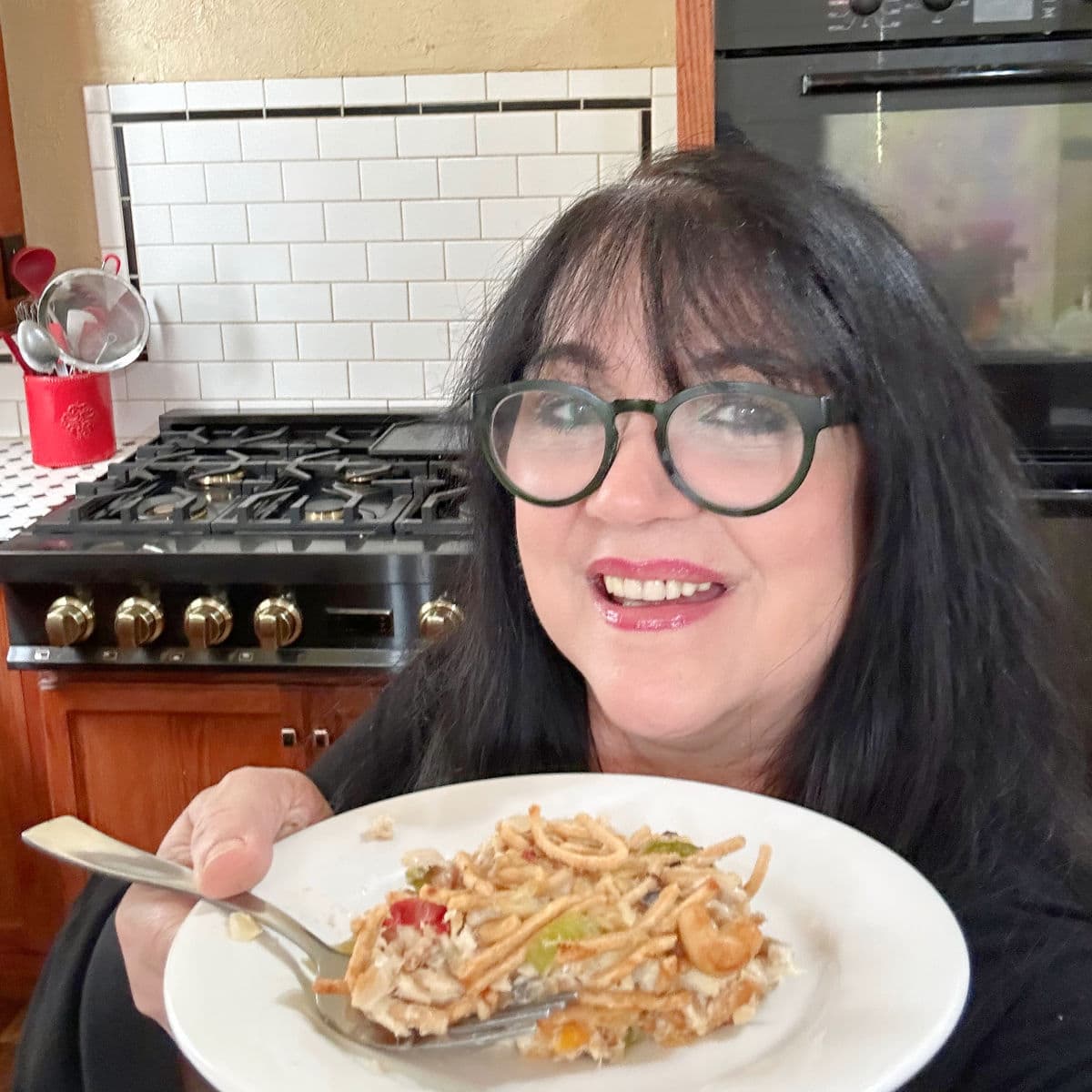 Marye Audet, author and recipe developer, holding a dish of her mom's chopstick tuna salad.