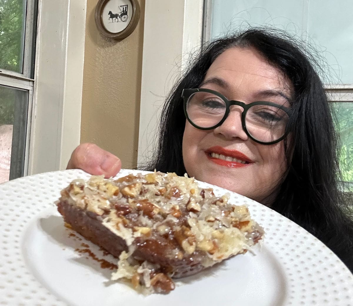 Marye Audet holding a piece of her mom's Texas Tornado cake.