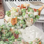 Pea salad being spooned out of a bowl with a title text overlay for Pinterest.