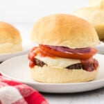 Homemade burger buns on a plate.