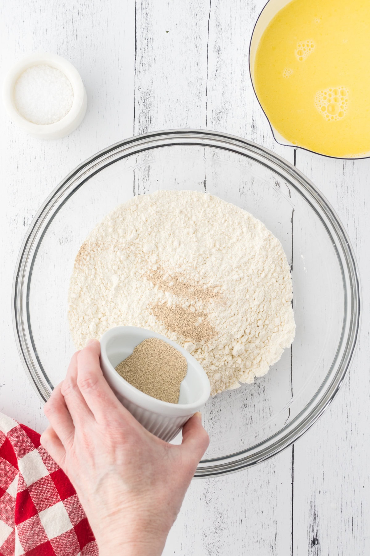 Yeast and salt being added to flour.