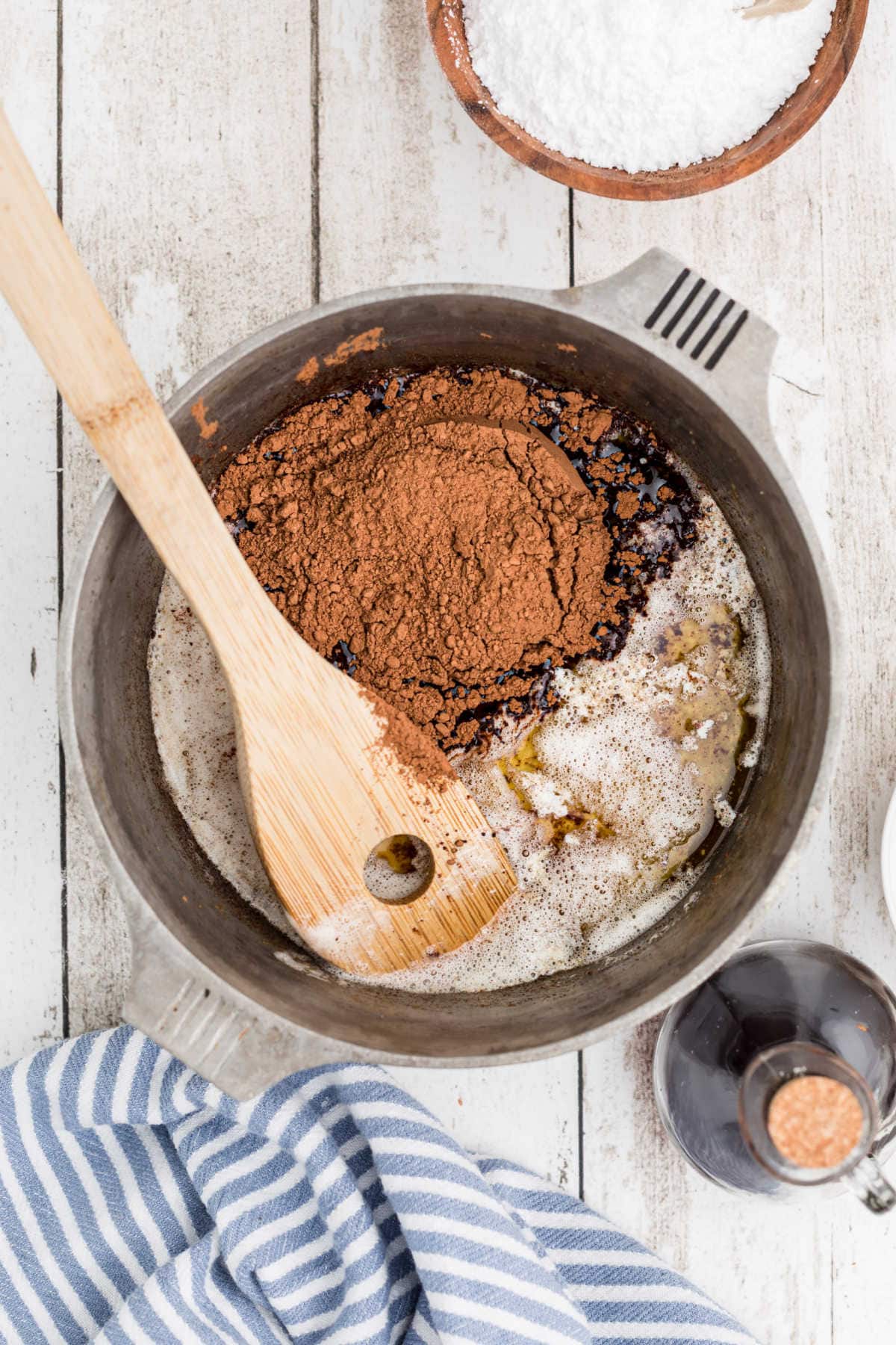 Buttermilk and cocoa are added to the butter in the pan.