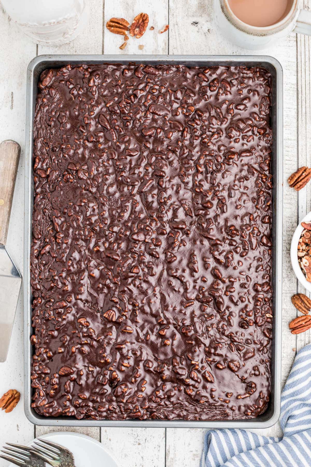 The hot icing is poured over the top of the cake.
