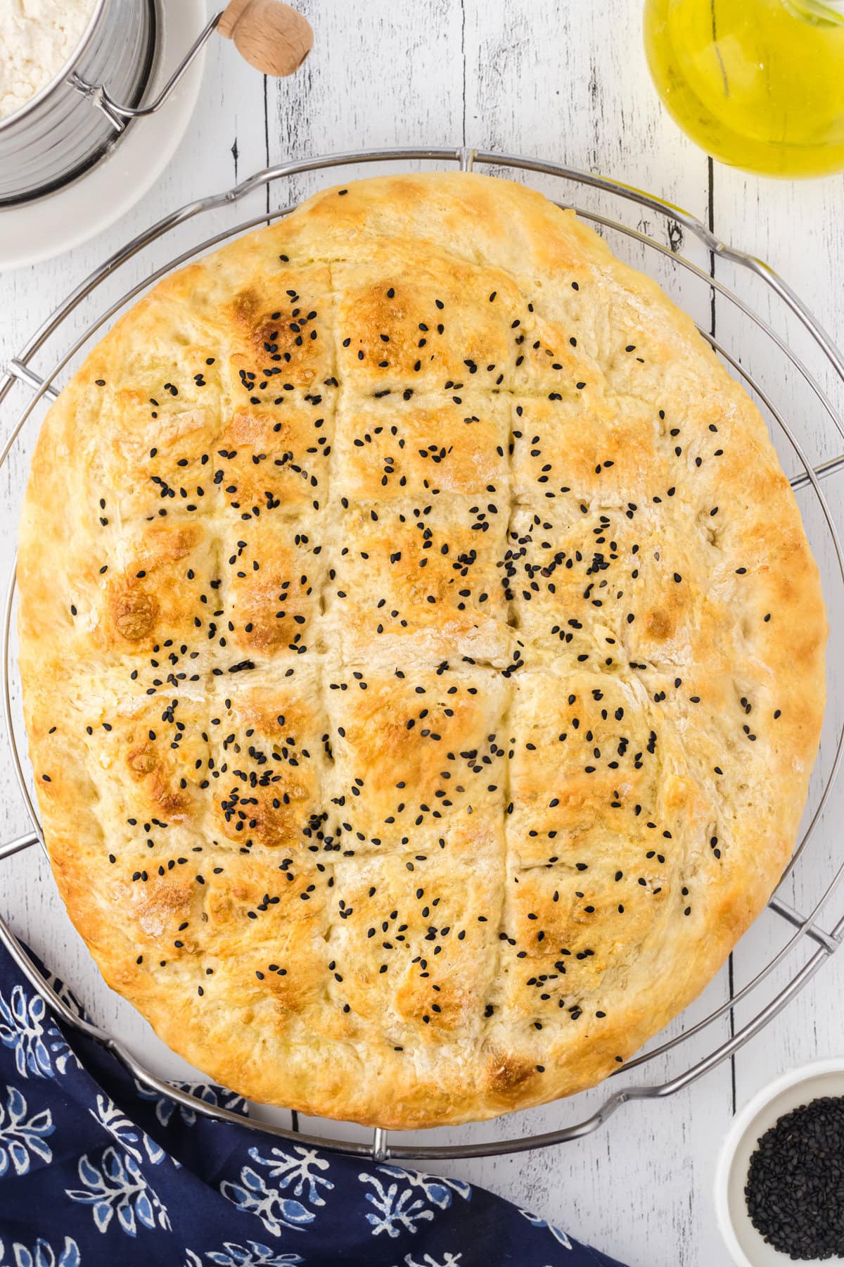 Baked Turkish bread on a wire rack.