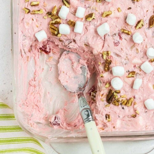 Overhead view of creamy pink salad with marshmallows on top.