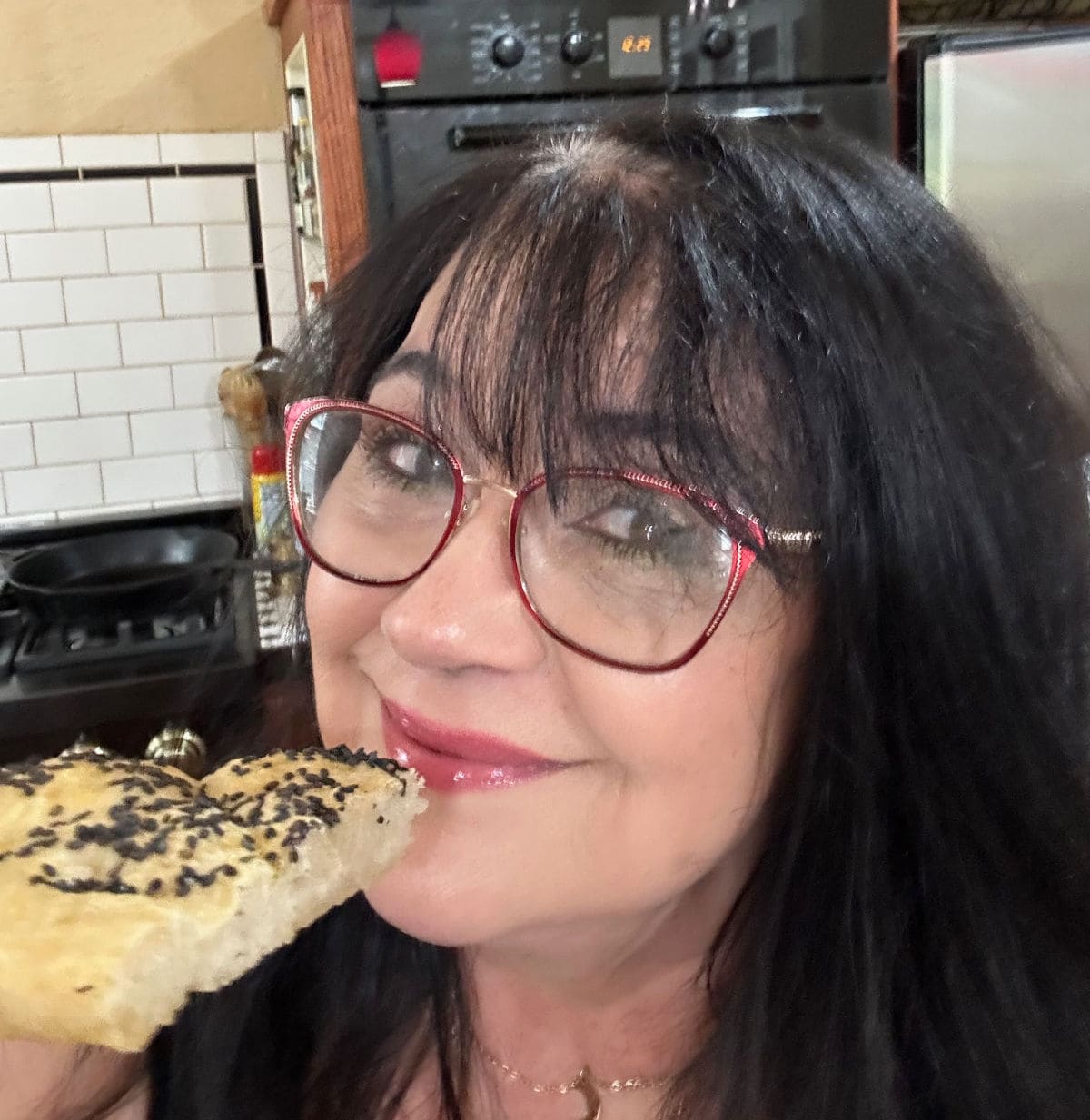 Marye Audet enjoying a slice of homemade Turkish bread.