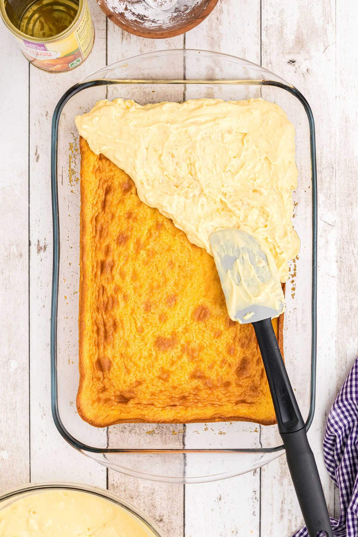 Topping being spread on cake.