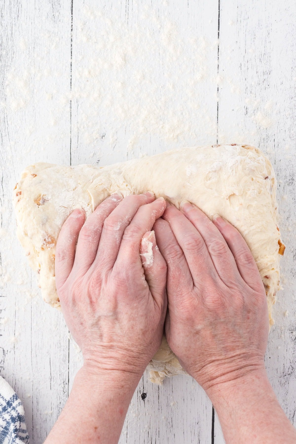 Hands kneading bread dough.