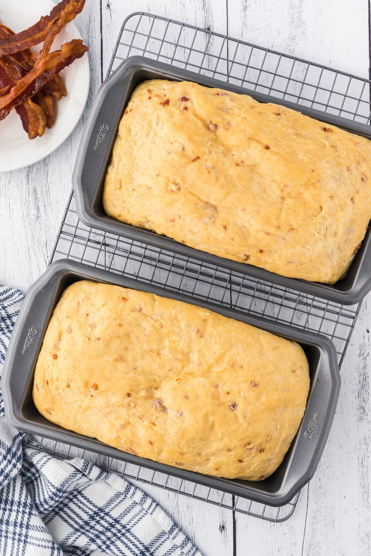 Baked loaves cooling on a wire rack.