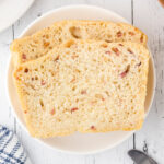 2 slices of bacon bread on a plate.