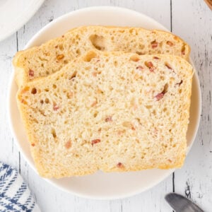 2 slices of bacon bread on a plate.