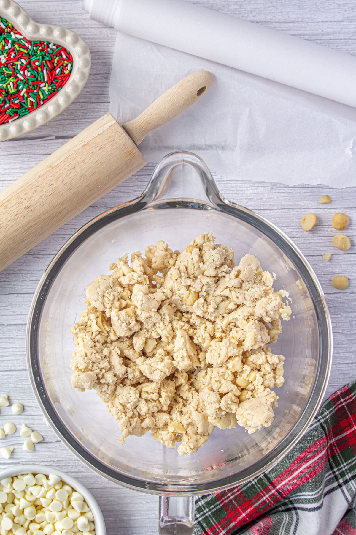 Butter, sugar, and flour creamed together in a glass bowl.