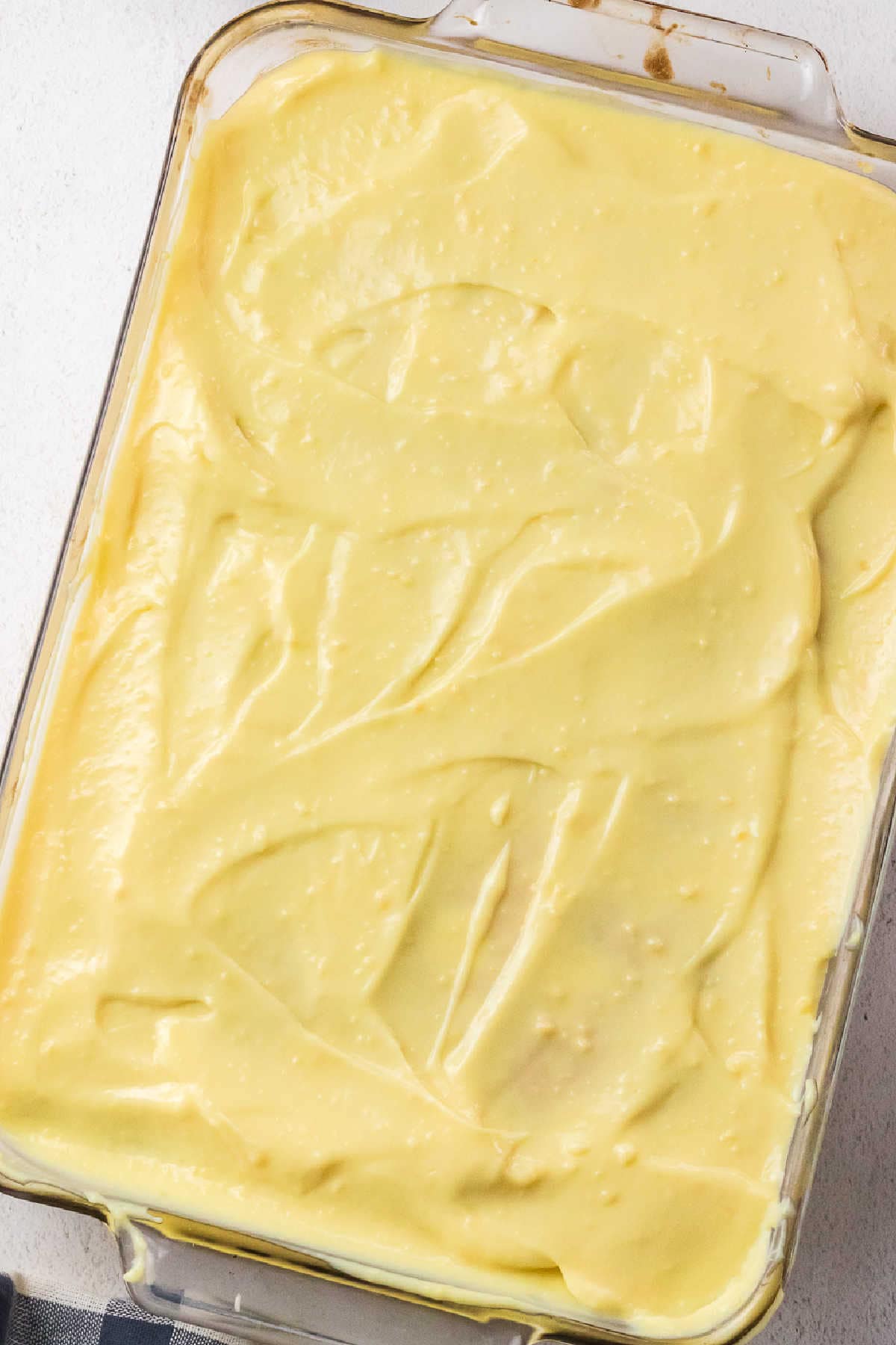Pudding covering cake.