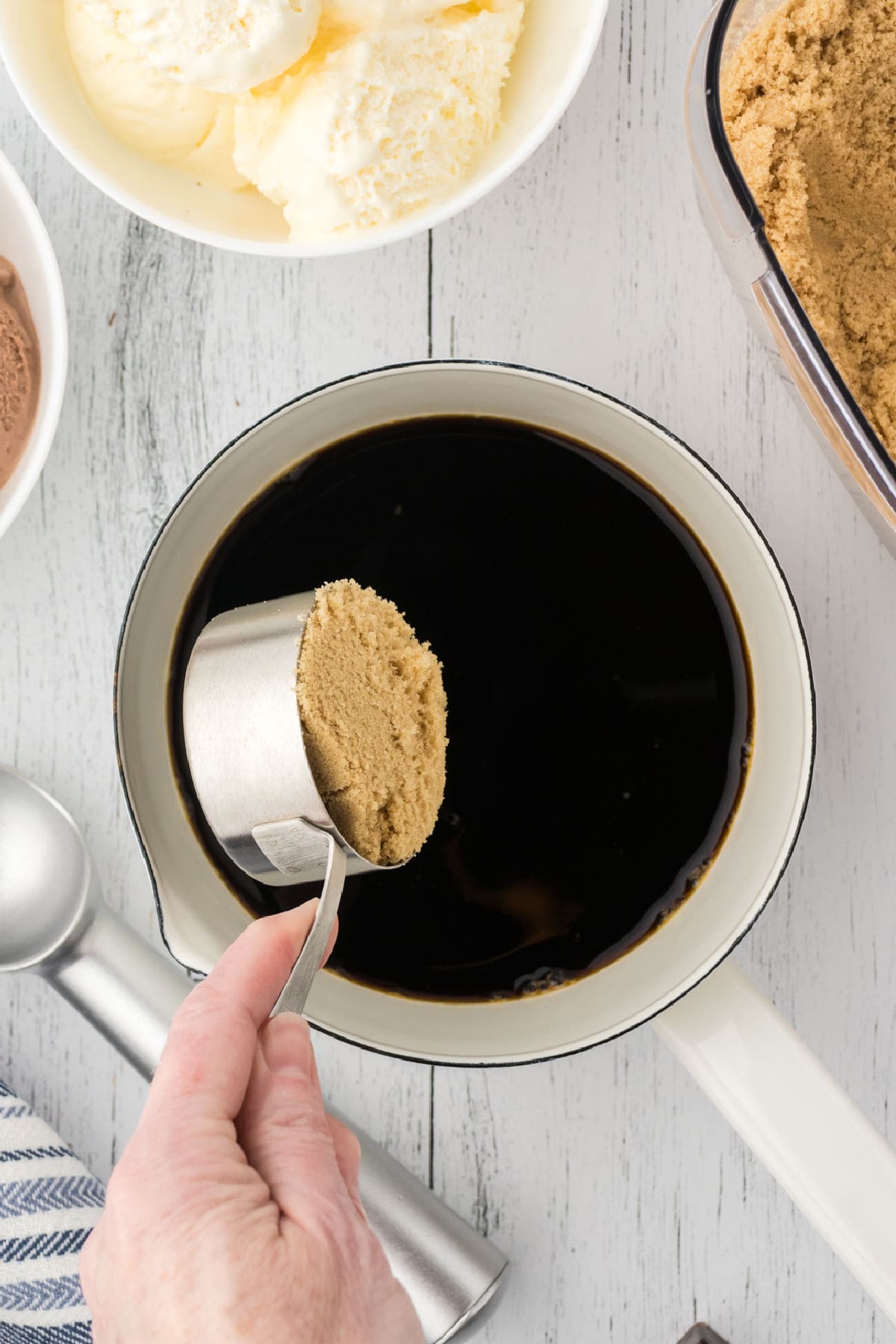 Brown sugar being mixed with coffee.
