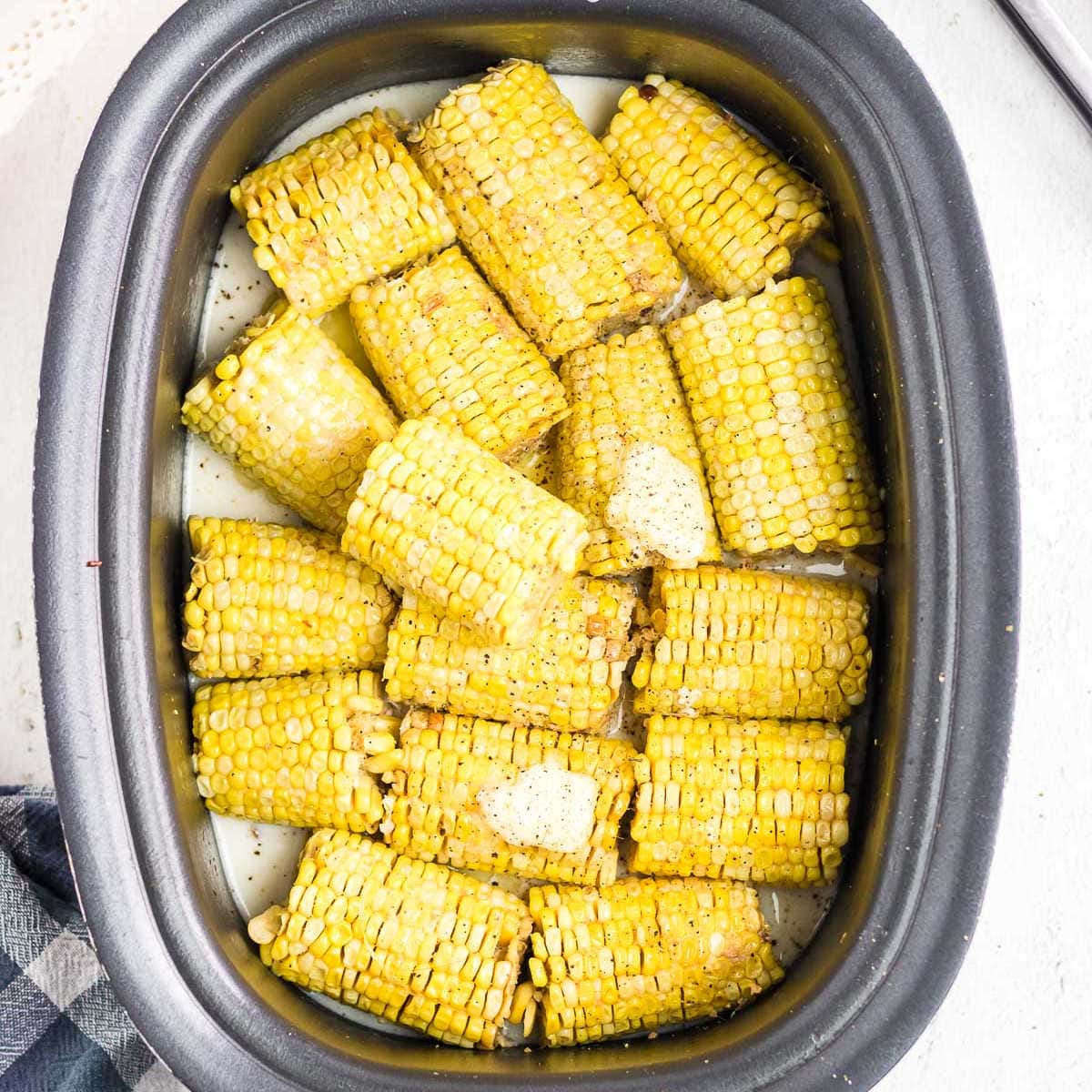 Overhead view of corn on the cob in a crockpot.