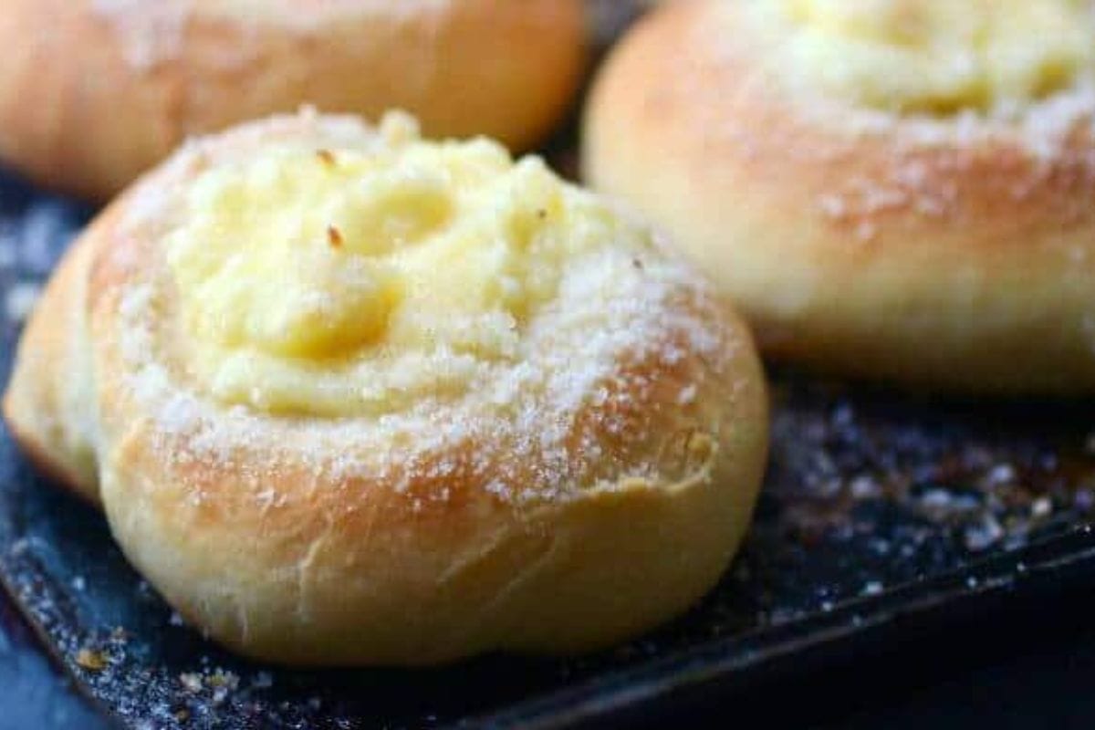Closeup of cream cheese kolache on a baking sheet.