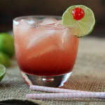 A cocktail on a dark background with title text overlay for Pinterest.
